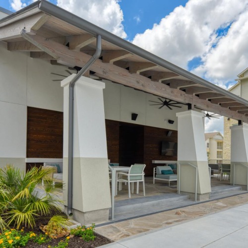 covered patio with tables and chairs